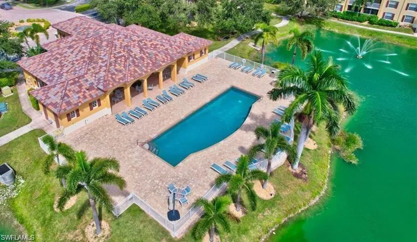 Birds eye view of property with a water view
