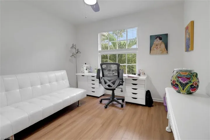 Home office with light wood-type flooring
