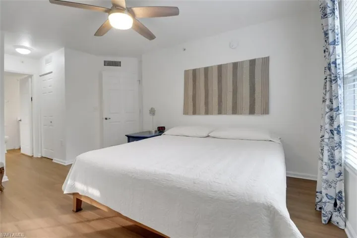Bedroom with ceiling fan and hardwood / wood-style flooring