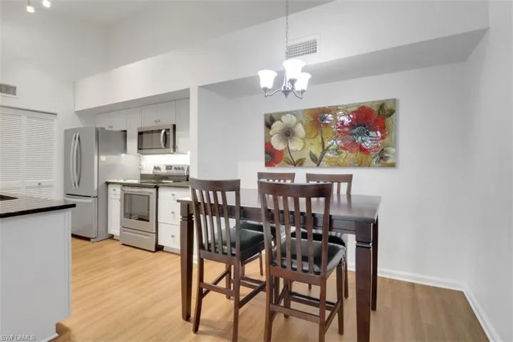 Dining room with an inviting chandelier and light hardwood / wood-style flooring