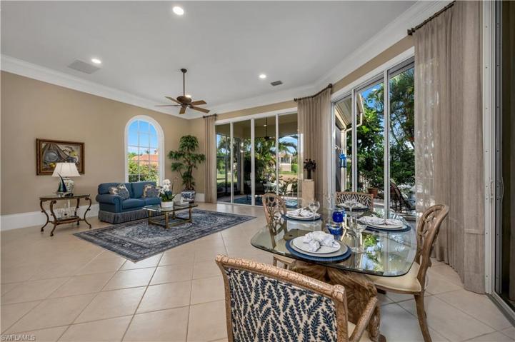 This bright breakfast nook has views to the garden, lake, and pool outside.  Open floor concept with the kitchen overlooking this room.