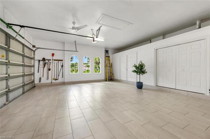 This garage is almost a man cave with tiled flooring and custom storage closets.