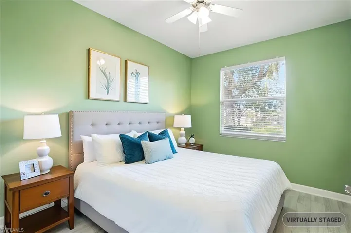 Bedroom featuring wood finished floors and ceiling fan - Virtually Edited Image