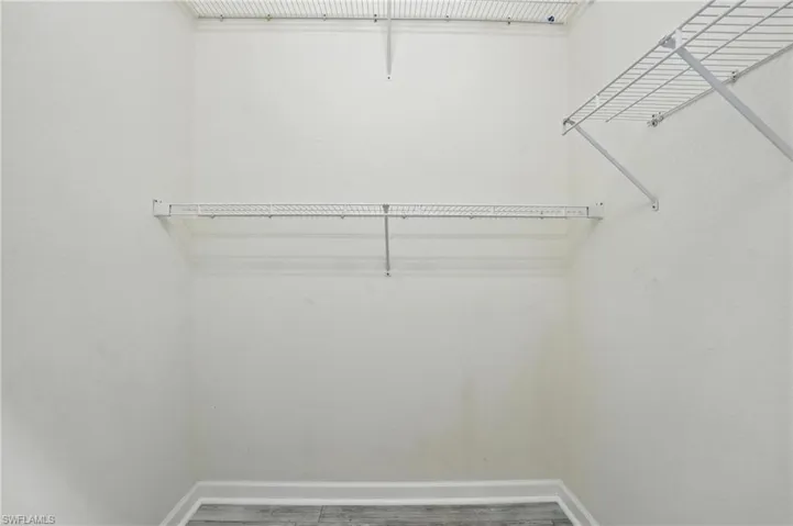 Spacious closet featuring wood finished floors - Virtually Edited Image