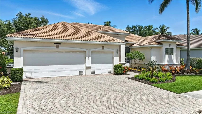 Mediterranean / spanish-style home featuring driveway, an attached garage, stucco siding, and a tile roof - Virtually Edited Image
