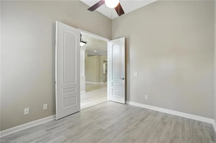 Unfurnished bedroom featuring light wood finished floors and ceiling fan - Virtually Edited Image