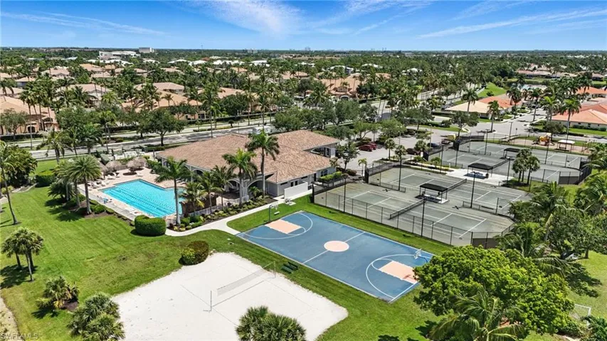 Aerial perspective of suburban area featuring a pool area - Virtually Edited Image