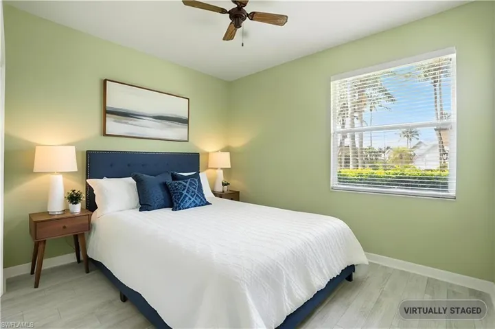 Bedroom with wood finished floors and ceiling fan - Virtually Edited Image