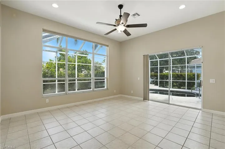 Living room or Breakfast nook featuring ceiling fan, light tile patterned floors, and recessed lighting - Virtually Edited Image