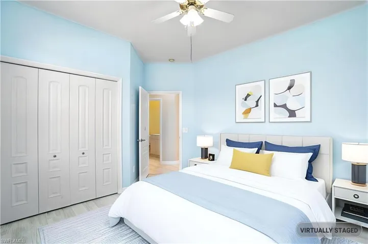 Bedroom with a closet, ceiling fan, and wood finished floors - Virtually Edited Image