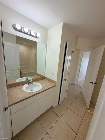 Bathroom with vanity and light tile patterned floors