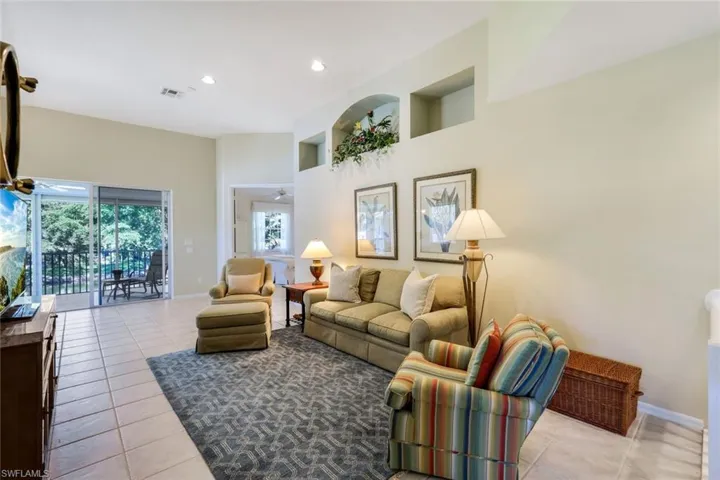 Tiled living room featuring recessed lighting, visible vents, baseboards, and a ceiling fan
