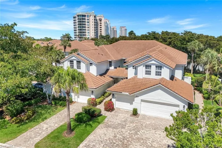 View of front of home featuring a tiled roof, decorative driveway, an attached garage, and stucco siding