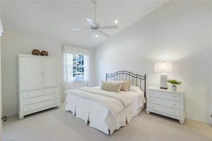 Bedroom with a ceiling fan, baseboards, lofted ceiling, recessed lighting, and light carpet