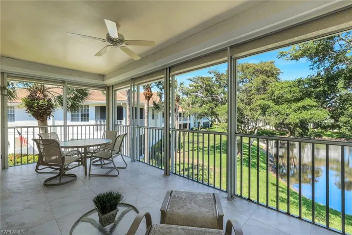 Sunroom with a healthy amount of sunlight, ceiling fan, and a water view