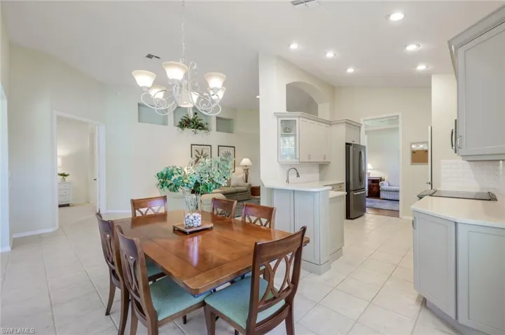 Dining room with recessed lighting, visible vents, lofted ceiling, and light tile patterned flooring