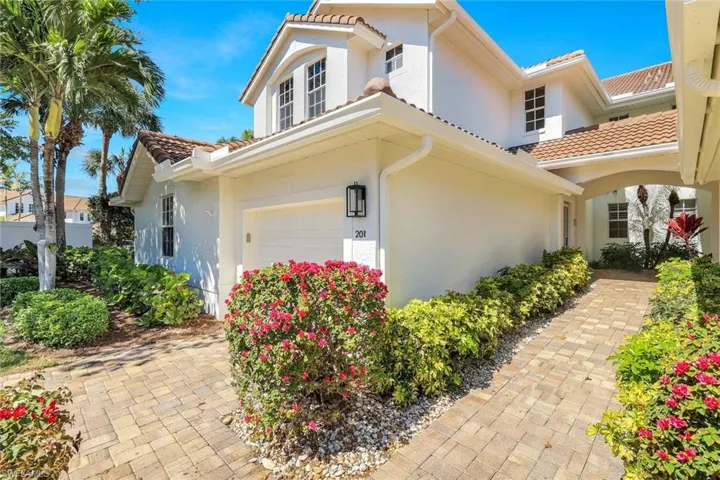View of front of house with stucco siding, an attached garage, and a tile roof