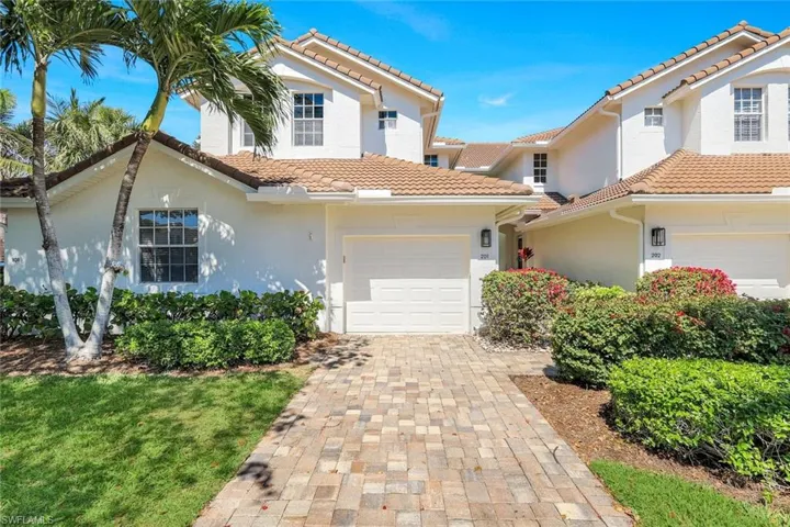 Mediterranean / spanish house with stucco siding, decorative driveway, an attached garage, and a tile roof