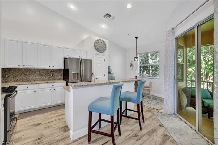 Nicely updated kitchen with white cabinetry and granite countertops.