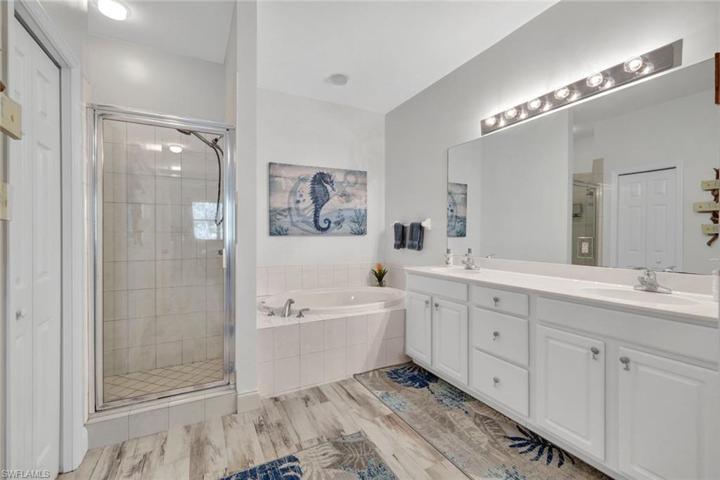 Primary bath with a separate tub for soaking & walk-in shower!