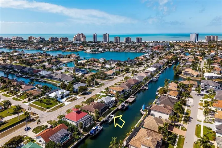 Aerial perspective of suburban area with a nearby body of water