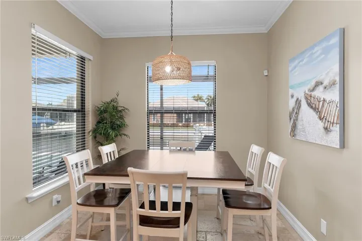 Dining room with baseboards and ornamental molding