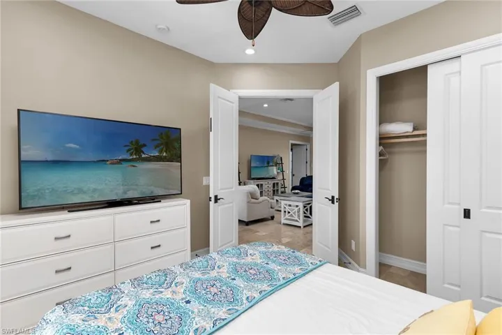 Laundry area with stone tile floors, cabinet space, and independent washer and dryer