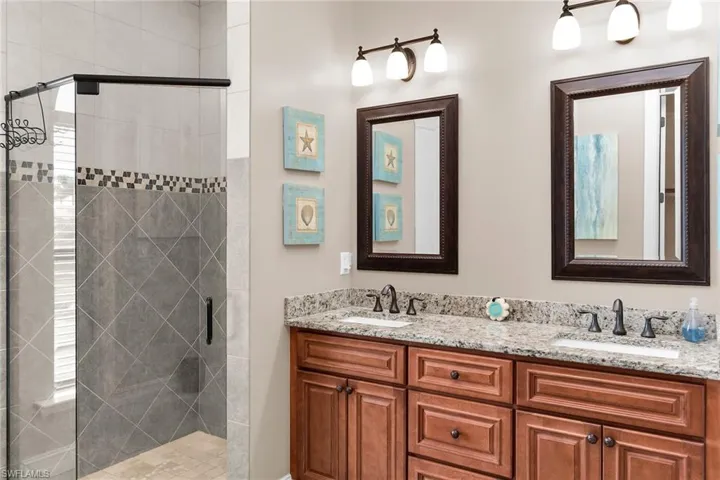 Bathroom with double vanity and a stall shower