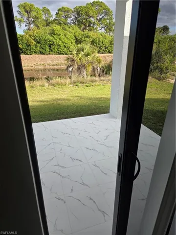 Entryway featuring marble look tiles