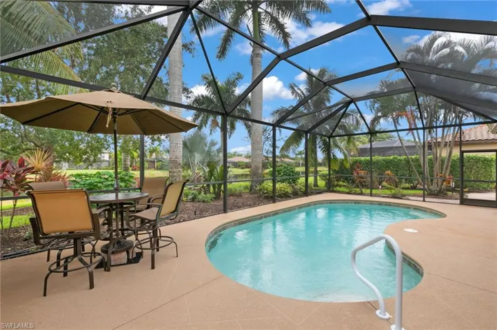 View of swimming pool with a lanai and a patio area