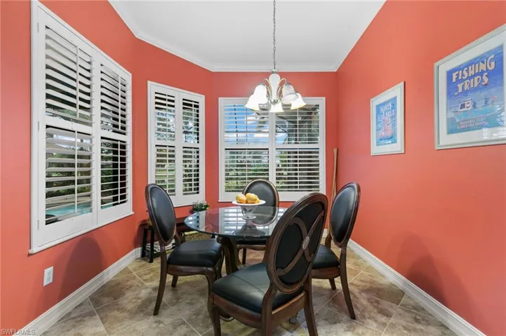 Dining room with an inviting chandelier and crown molding