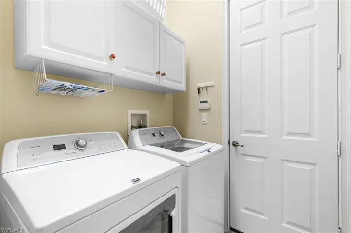 Washroom with independent washer and dryer and cabinets