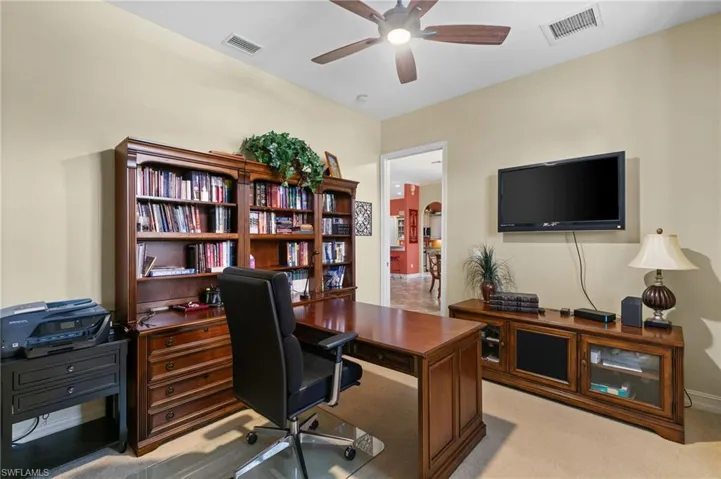 Carpeted office space with ceiling fan
