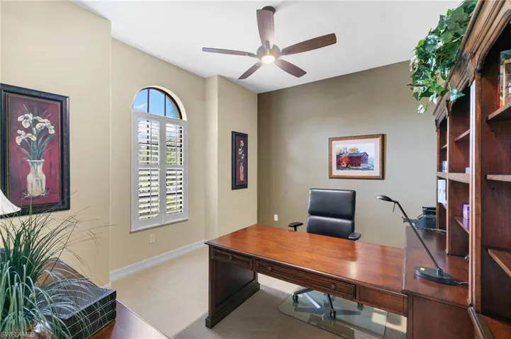 Carpeted office with ceiling fan