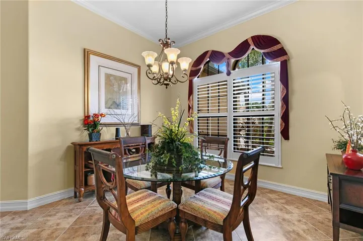 Dining area with crown molding and an inviting chandelier