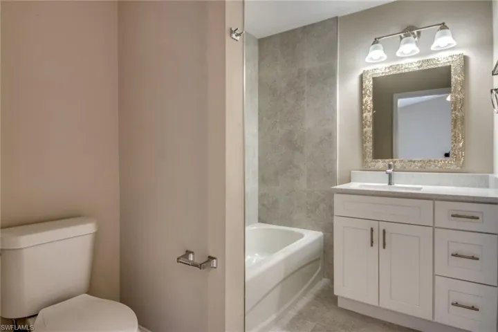 Bathroom with tile patterned floors, vanity, and toilet