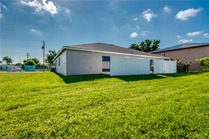 Rear view of house with a lawn