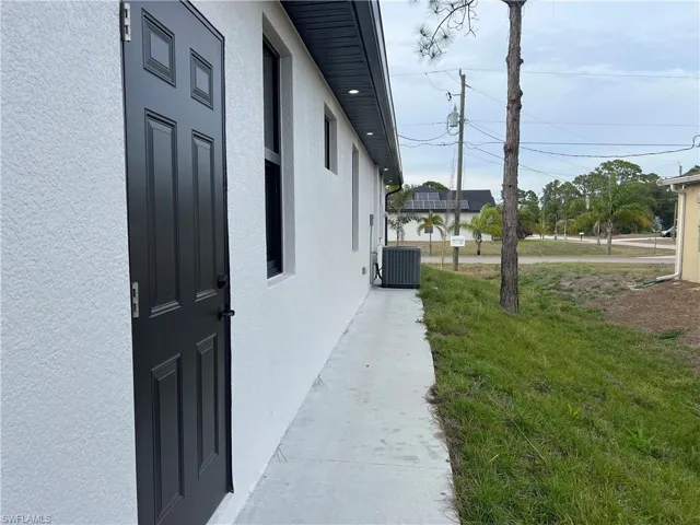 View of efficiency door and side walk