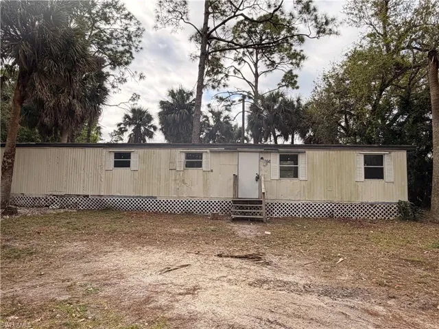 View of front of house with entry steps and a deck