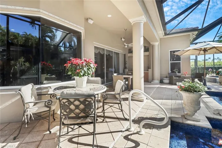 View of patio / terrace featuring glass enclosure, sink, and area for grilling