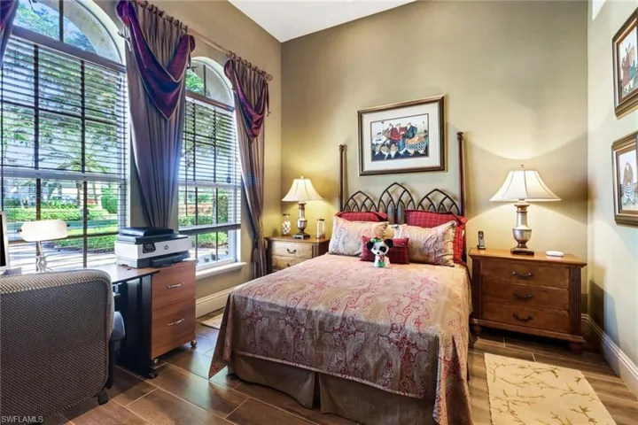Bedroom with a closet, ceiling fan, ornamental molding, and hardwood / wood-style flooring