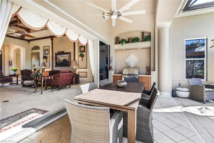 Full bathroom with ceiling fan, shower / bath combo with shower curtain, vanity, and toilet