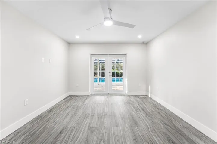 Master Bedroom with French doors going to the pool, wood tile floors, ceiling fan, and recessed lighting