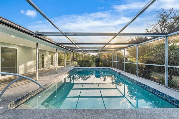 Swimming pool featuring sliding doors from Living room, French doors from Master, a pool bath entrance, a lanai, and a patio