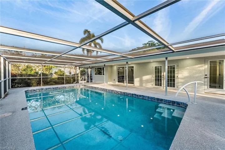 Swimming pool featuring a lanai, and a patio