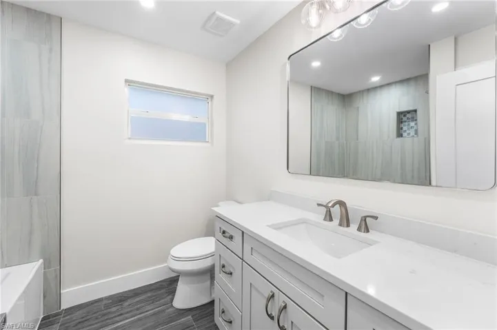 Guest Full bathroom featuring vanity, a bath, recessed lighting, and a tile shower