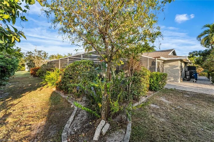 Side and back of home lushly landscaped