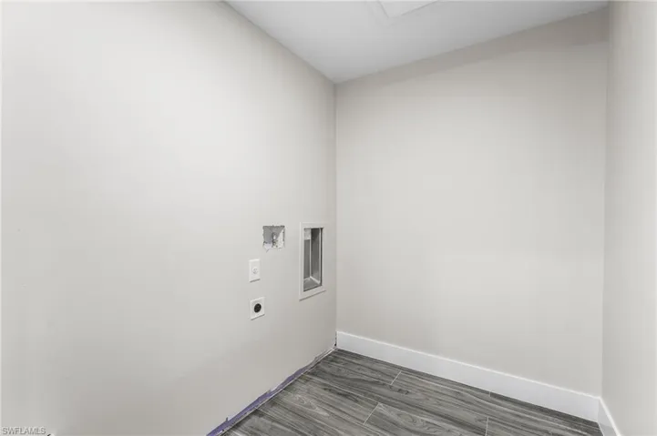Laundry room with wood-style tile flooring, hookup for an electric dryer, and hookup for a washing machine