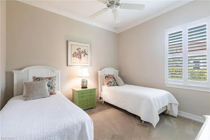 2nd Bedroom featuring crown molding, carpet floors, and ceiling fan with plenty of natural light.