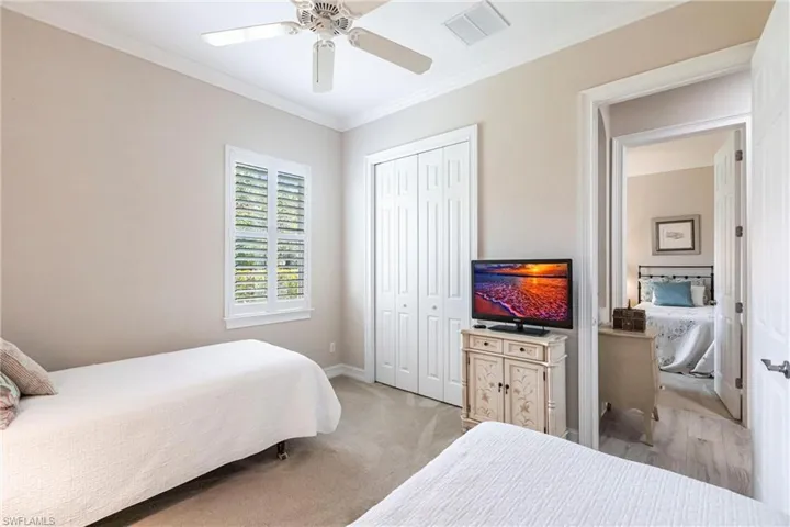 2nd Bedroom featuring crown molding, light colored carpet, a closet, and ceiling fan
